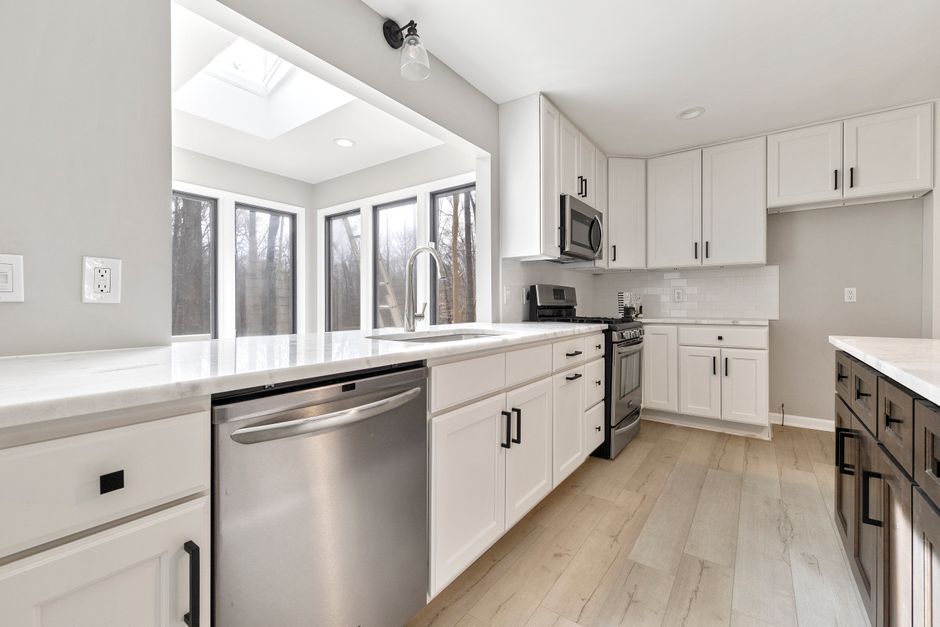 Bright contemporary kitchen with sleek stainless steel appliances and ample natural light.